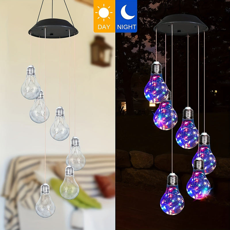 The same chime shown unlit by day and lit in color by night