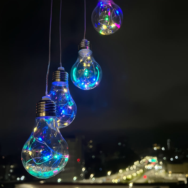 Close view of three bulbs showing the fine copper LED wire coiled inside each glass globe