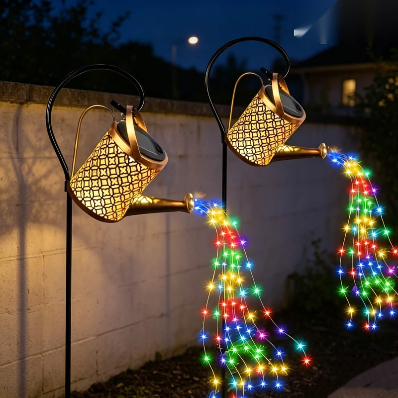 Two color changing solar watering can string lights side by side