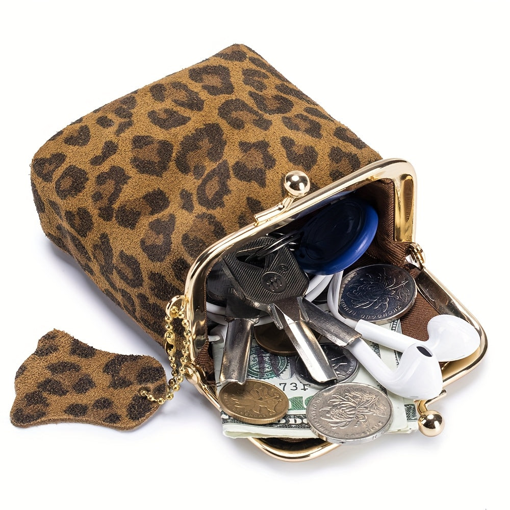 Purse open showing keys, coins, earbuds and folded bills inside
