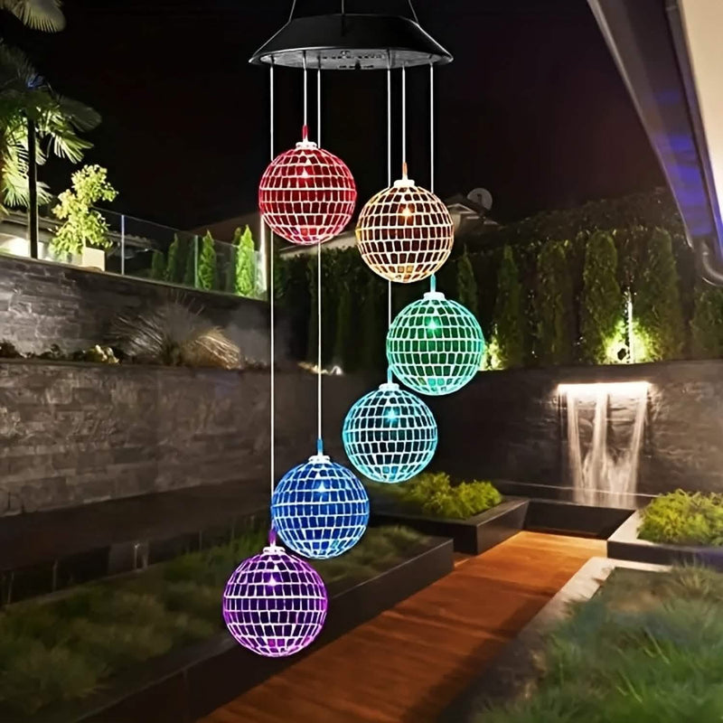 Lit in color hanging over a garden path at night
