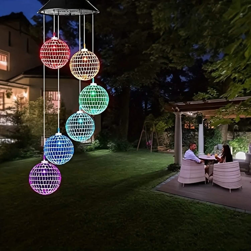 Lit in color over a lawn and patio at night