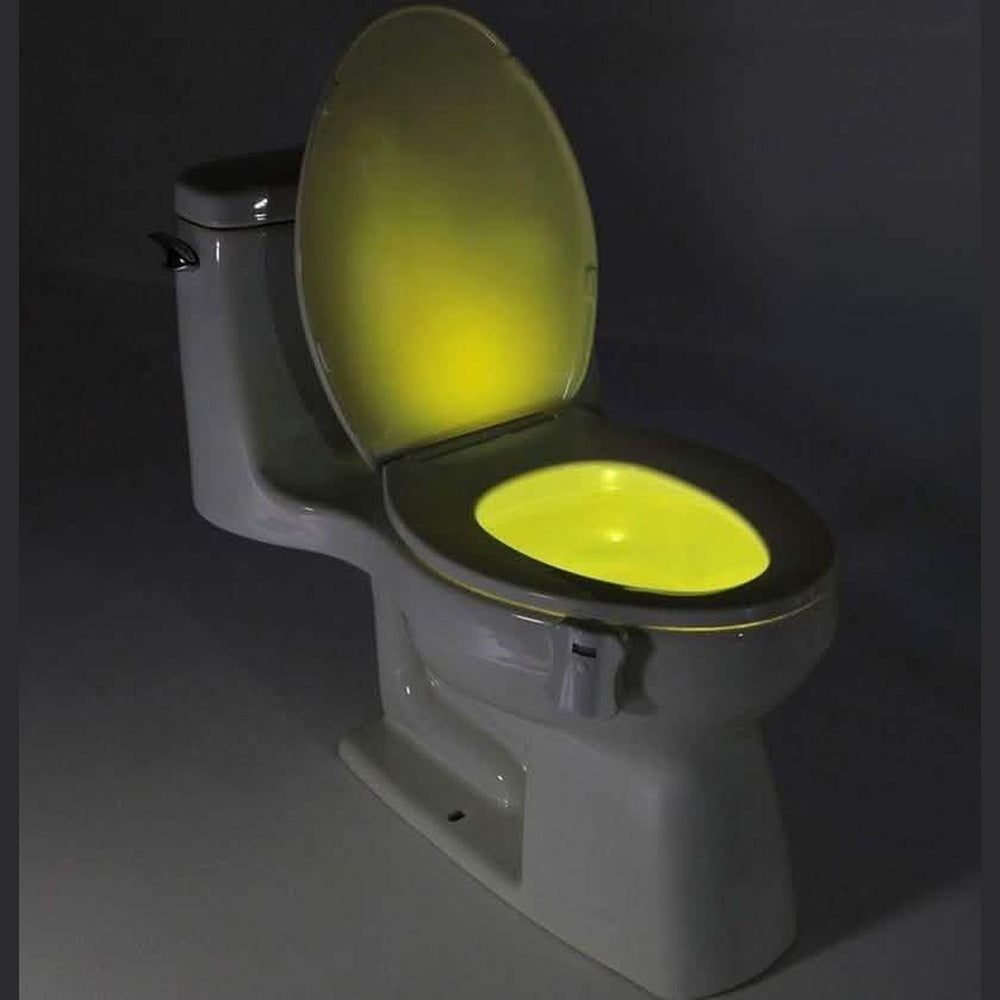 Motion-activated LED toilet light illuminating a toilet bowl