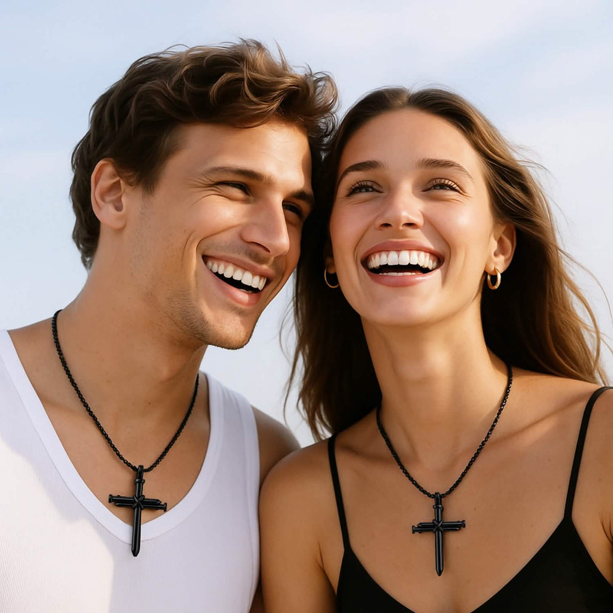 A couple each wearing the black cross necklace