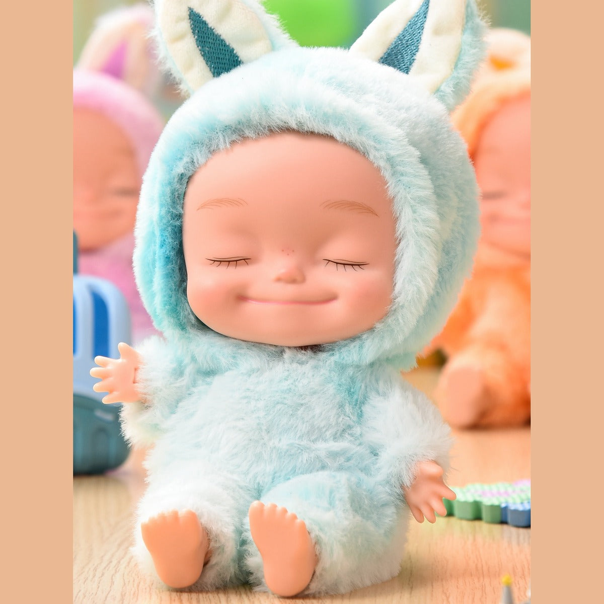 Blue plush onesie doll with eyes closed, seated
