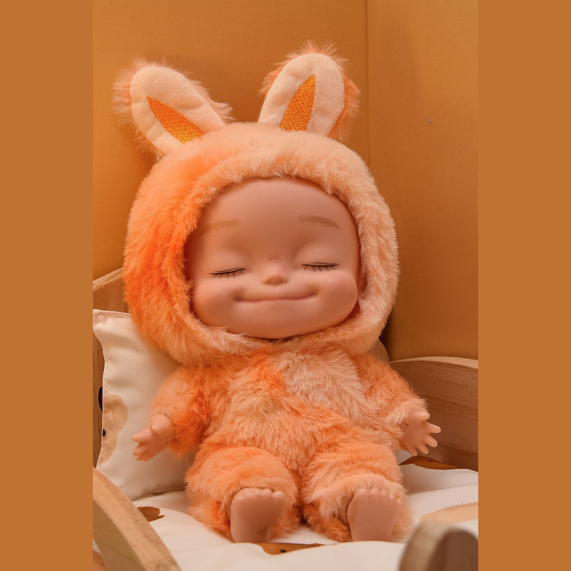 Orange plush onesie doll with eyes closed, seated in a wooden toy bed