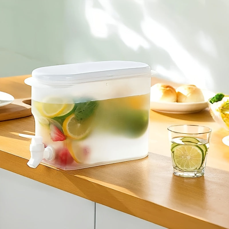 Drink dispenser on a kitchen counter filled with fruit and ice