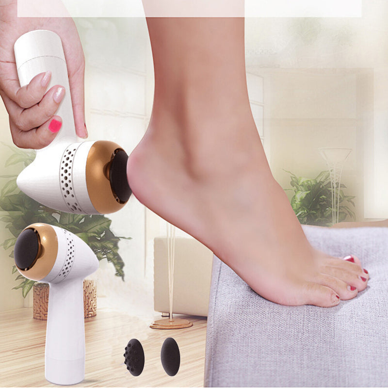 Electric foot file being used on a heel, with two spare grinding heads