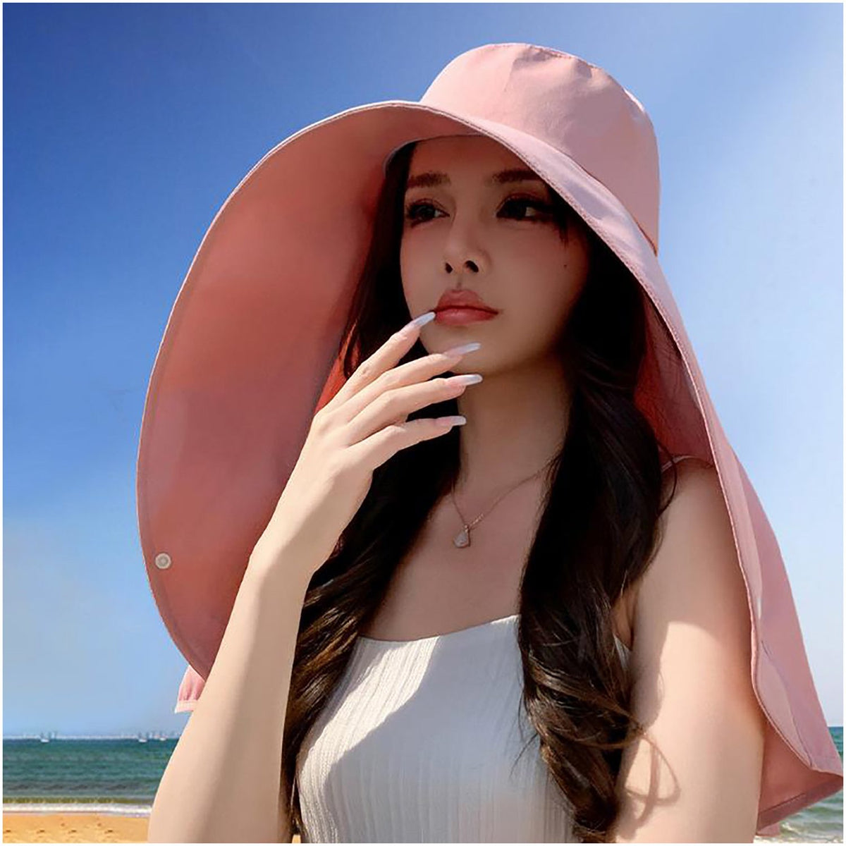 Pink sun hat worn at the beach