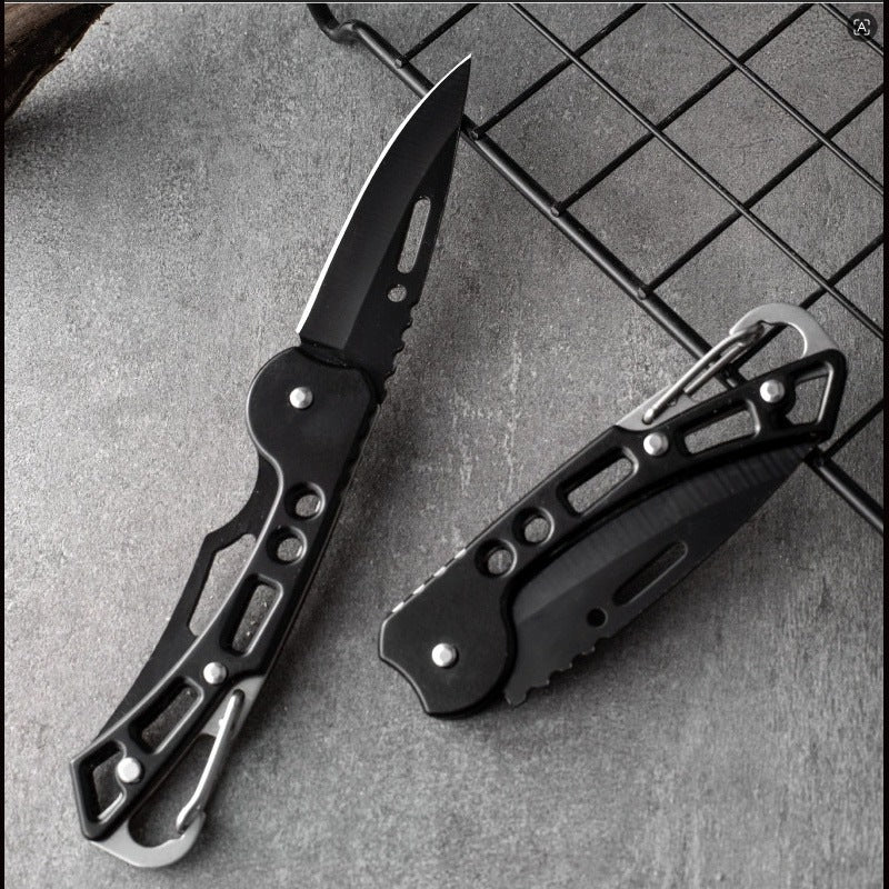 Two folding pocket knives on a slate surface