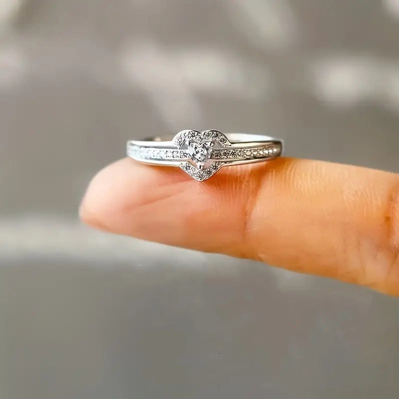 Silver heart ring on a fingertip