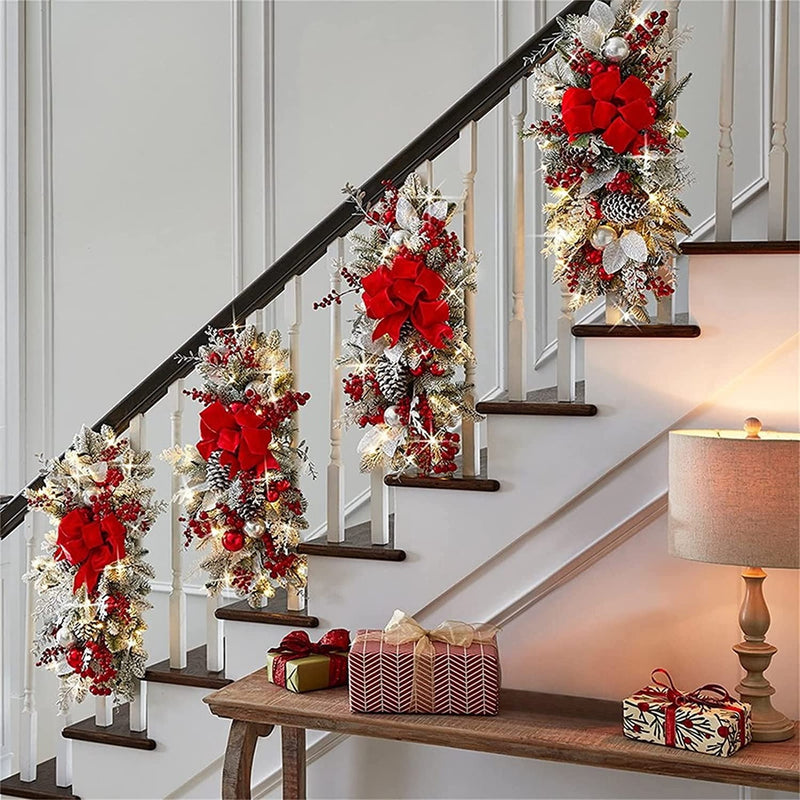 Four lit swags hung in a row down a staircase banister