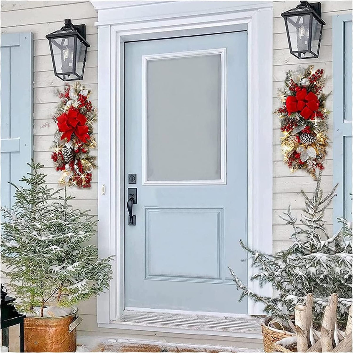 Pair of lit swags flanking a pale blue front door between two lanterns