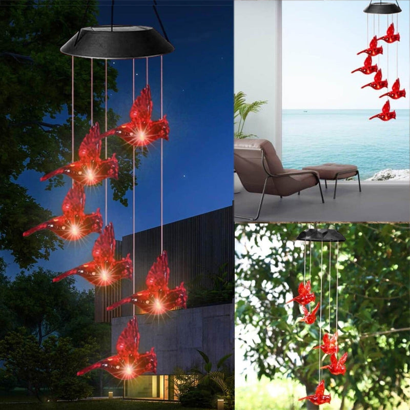Wind chime lit at night outside a house