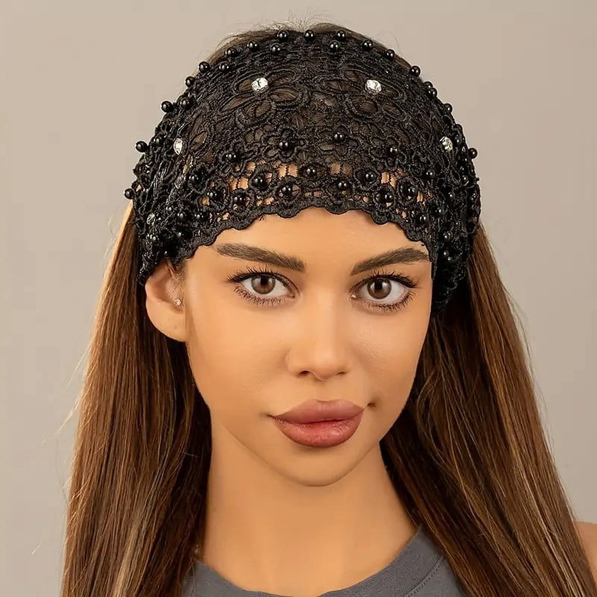The black crochet lace headband with pearls and rhinestones worn across the crown