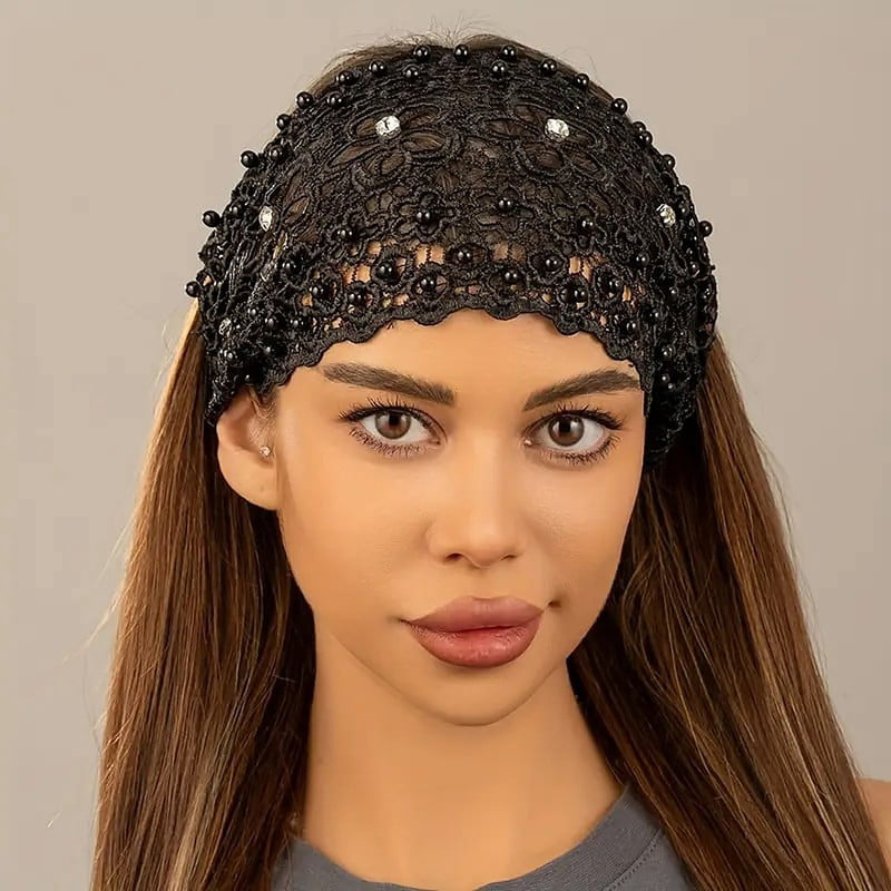 The black crochet lace headband with pearls and rhinestones worn across the crown