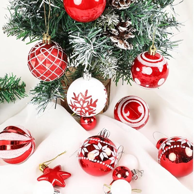 Decorated balls and a red star hanging among flocked branches
