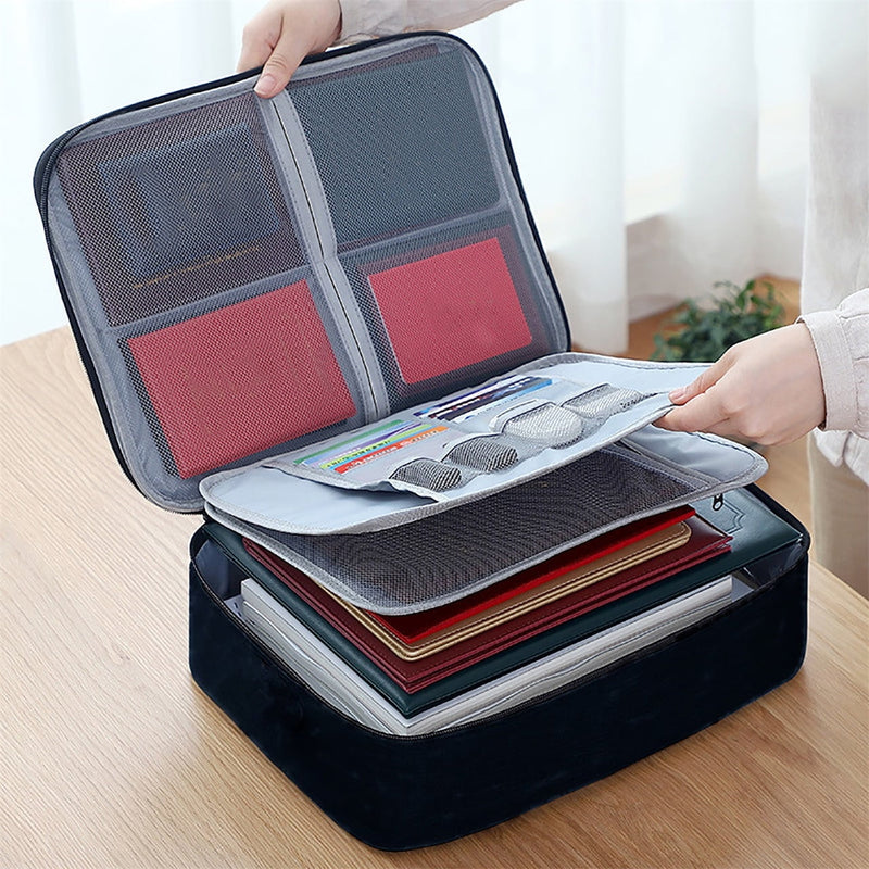 Navy document organizer box open on a desk with passports and folders inside