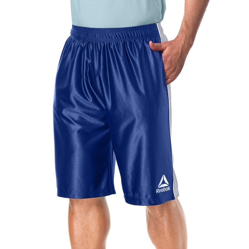 Man with one hand in his pocket modelling the Reebok Men's Two Toned Athletic Performance Dazzle Shorts With Pockets in dark blue