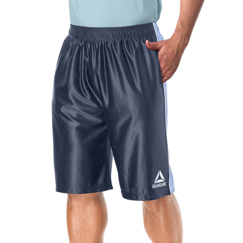 Man with one hand in his pocket modelling the Reebok Men's Two Toned Athletic Performance Dazzle Shorts With Pockets in grey
