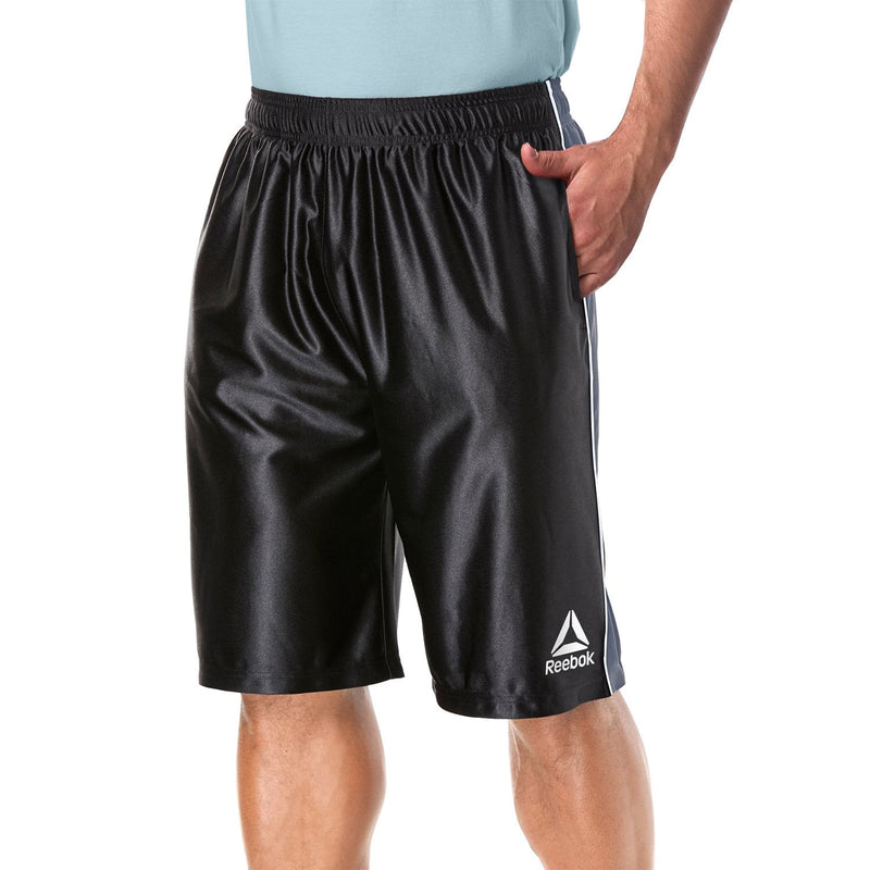 Man with one hand in his pocket modelling the Reebok Men's Two Toned Athletic Performance Dazzle Shorts With Pockets in black