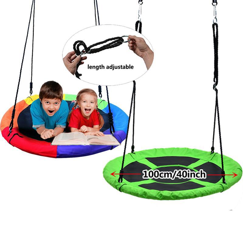 Children lying on a 40" Flying Saucer Tree Swing Chair Kids Round Hanging Rope Seat reading a book