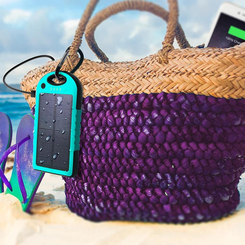 Aduro Powerup Solar 6,000 mAh Portable Backup Battery attached to a hand bag on a sand beach