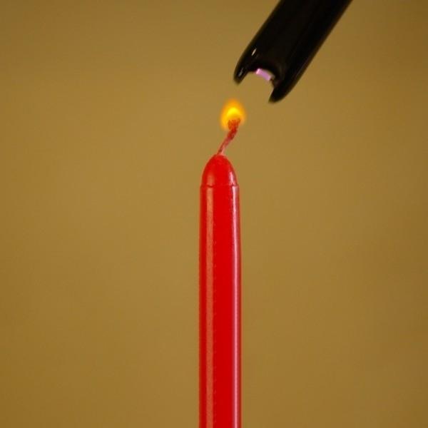 Atomic Lighter Reach Flameless Electronic Lighter lighting a candle