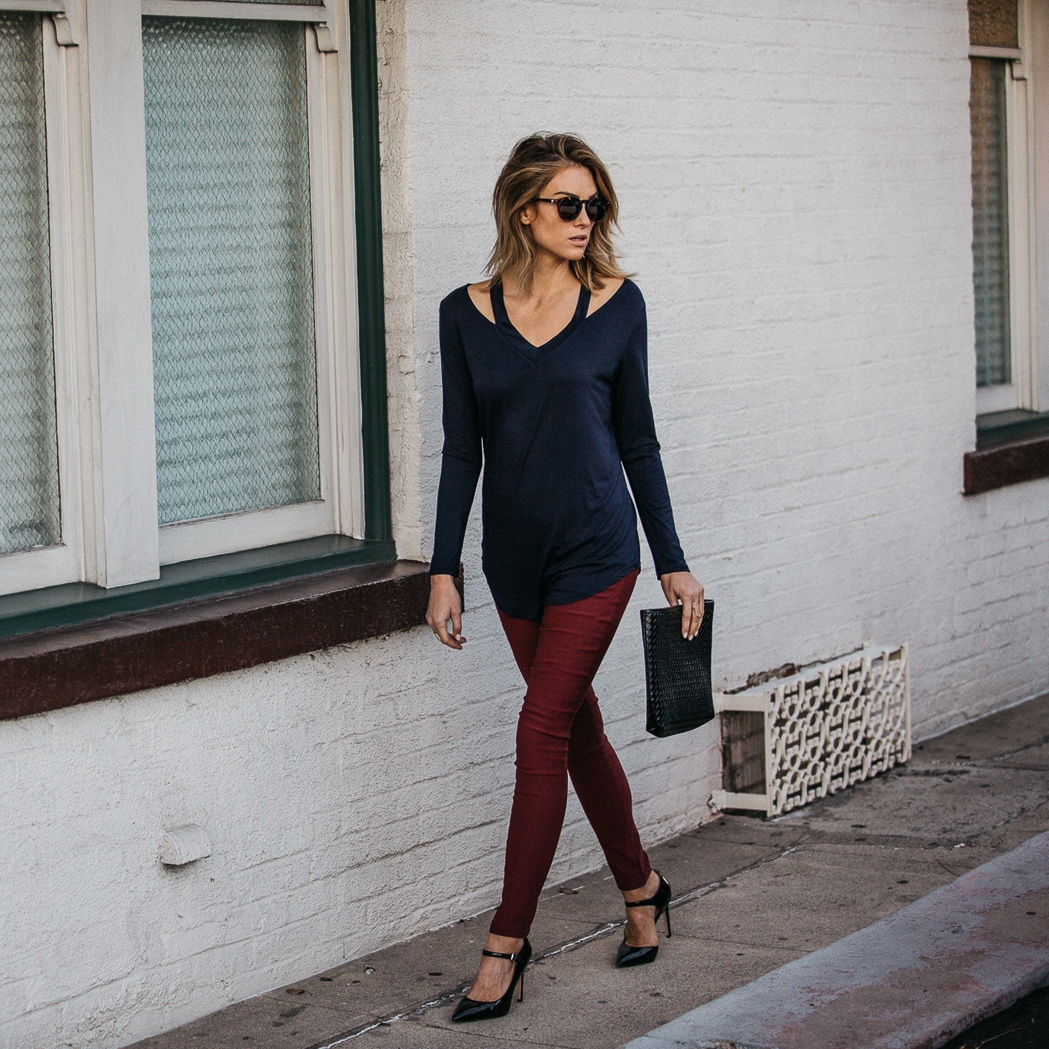 Woman in sun glasses walking on the side walk wearing a Cut Loose Long Sleeve Shirt in navy