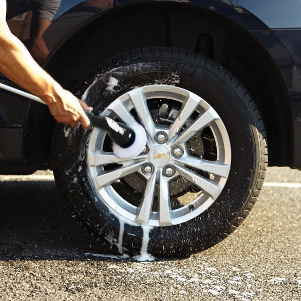 Demonstration of a man cleaning a car wheel using a Deluxe Hurricane Spin Scrubber