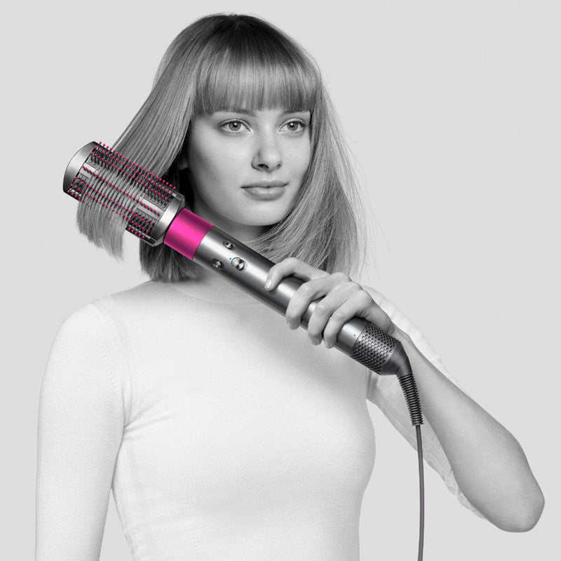 Woman with short hair using a Dyson Airwrap Complete Style For Multiple Hair Types And Styles to straighten her hair
