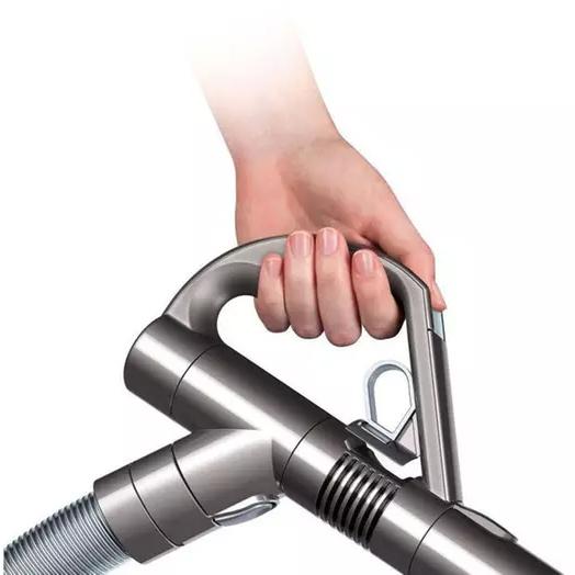 Closeup of a hand holding a purple Dyson DC39 Animal Canister Vacuum Cleaner (Refurbished) by its handle