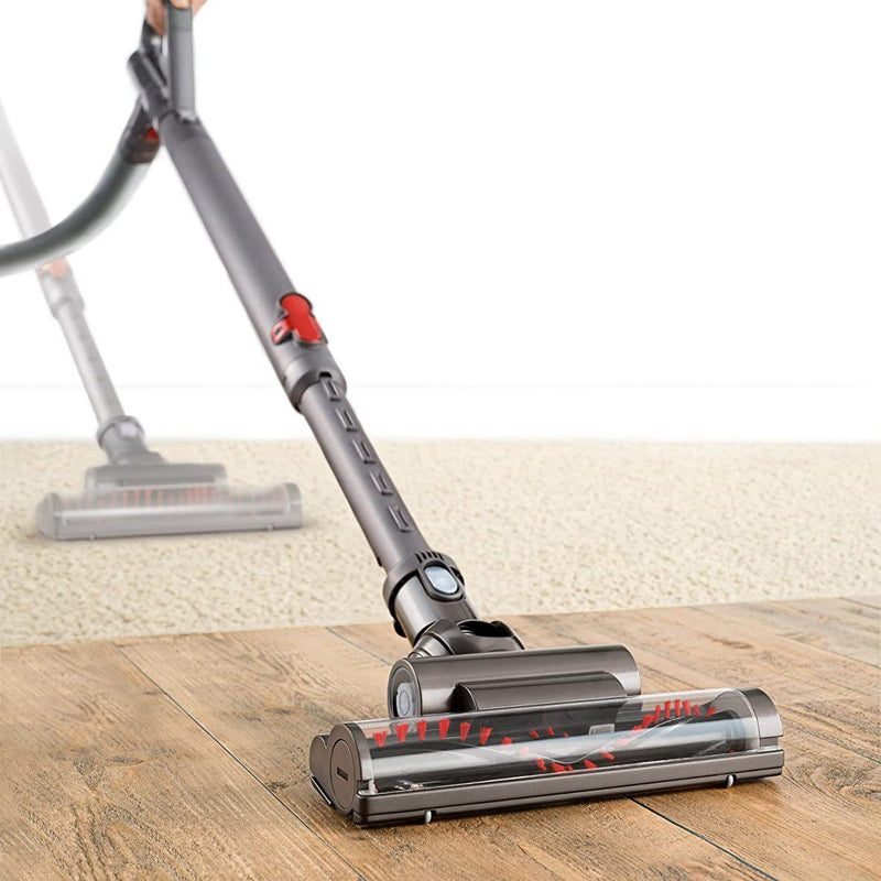 Purple Dyson DC39 Animal Canister Vacuum Cleaner (Refurbished) on display shown in action vacuuming both a carpeted floor and a hardwood floor