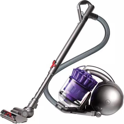 Closeup of a purple Dyson DC39 Animal Canister Vacuum Cleaner (Refurbished) on display standing on a floor surface in "vacuum" position
