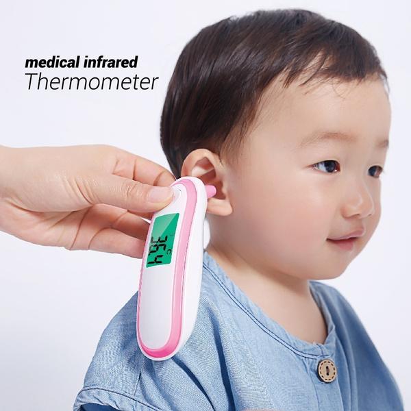 Hand holding an Infrared Thermometer taking the ear temperature of a toddler