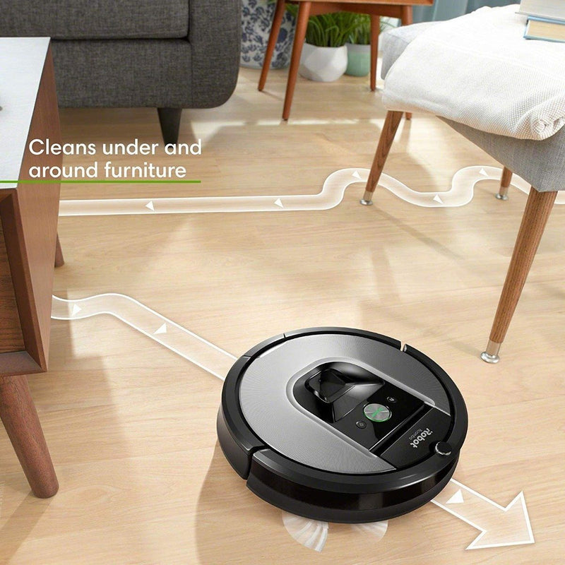 iRobot Roomba 960 Robot Vacuum in action shown navigating around a chair and a coffee table