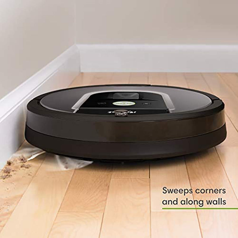 iRobot Roomba 960 Robot Vacuum shown in action sweeping corners and along a wall