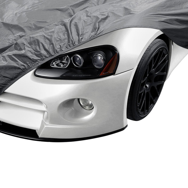 Front left fender of a car partially covered with OxGord CCAR-745 Universal Executive Gray Car Cover